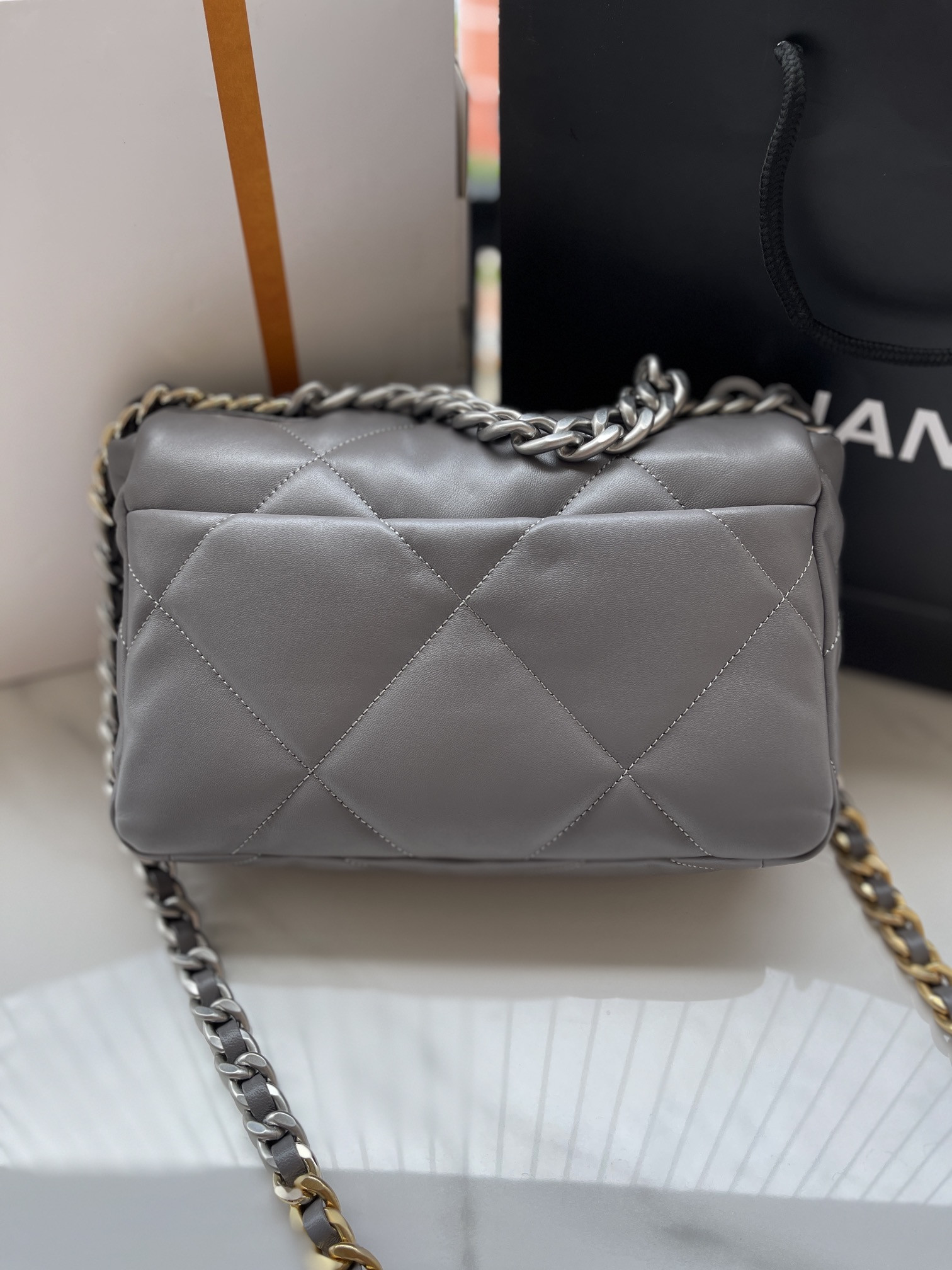 Ch*el 19 handbag shiny leather, gold-tone, silver-tone & ruthenium-finish metal dark gray 6.2 × 10.1 × 3.5 in