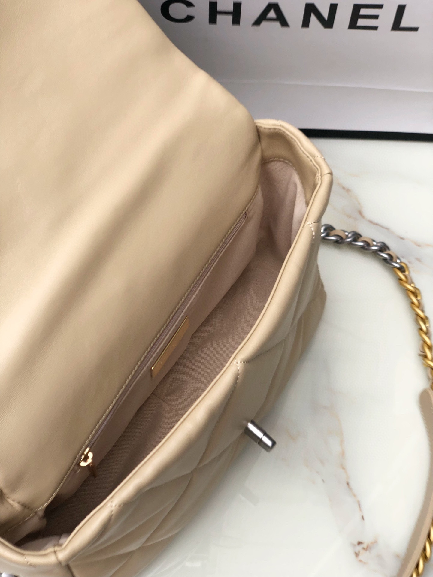Ch*el 19 handbag shiny leather, gold-tone, silver-tone & ruthenium-finish metal beige 30x20x10cm