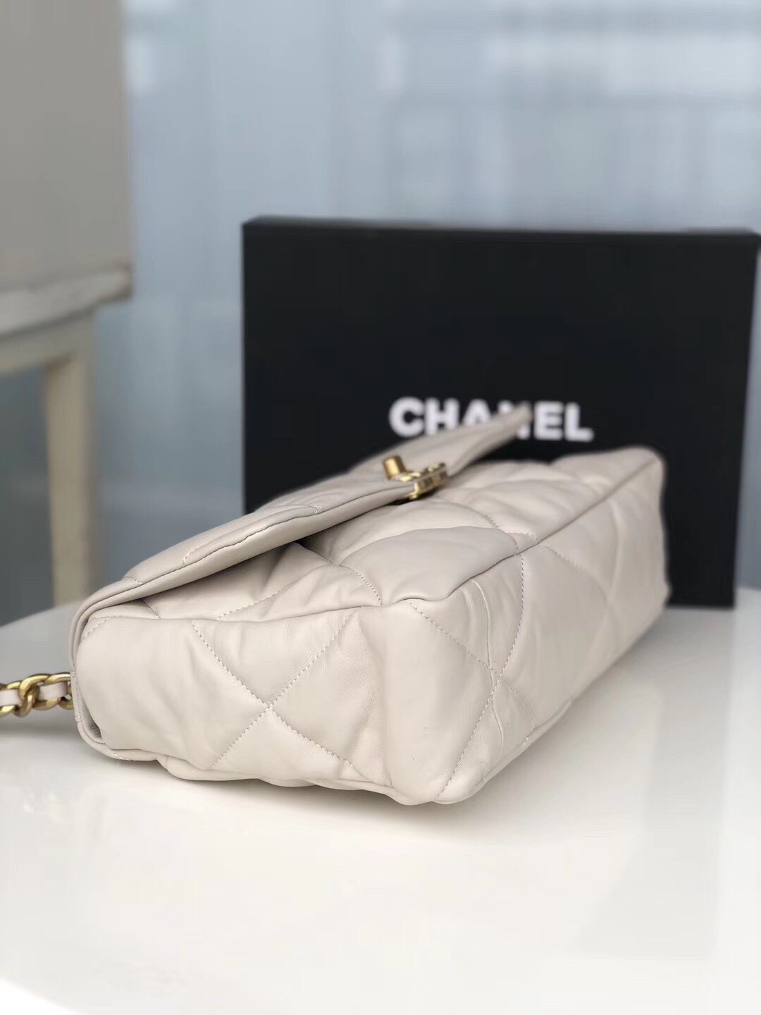 Ch*el 19 large handbag shiny leather, gold-tone, silver-tone & ruthenium-finish metal beige 7.8 × 11.7 × 3.9 in