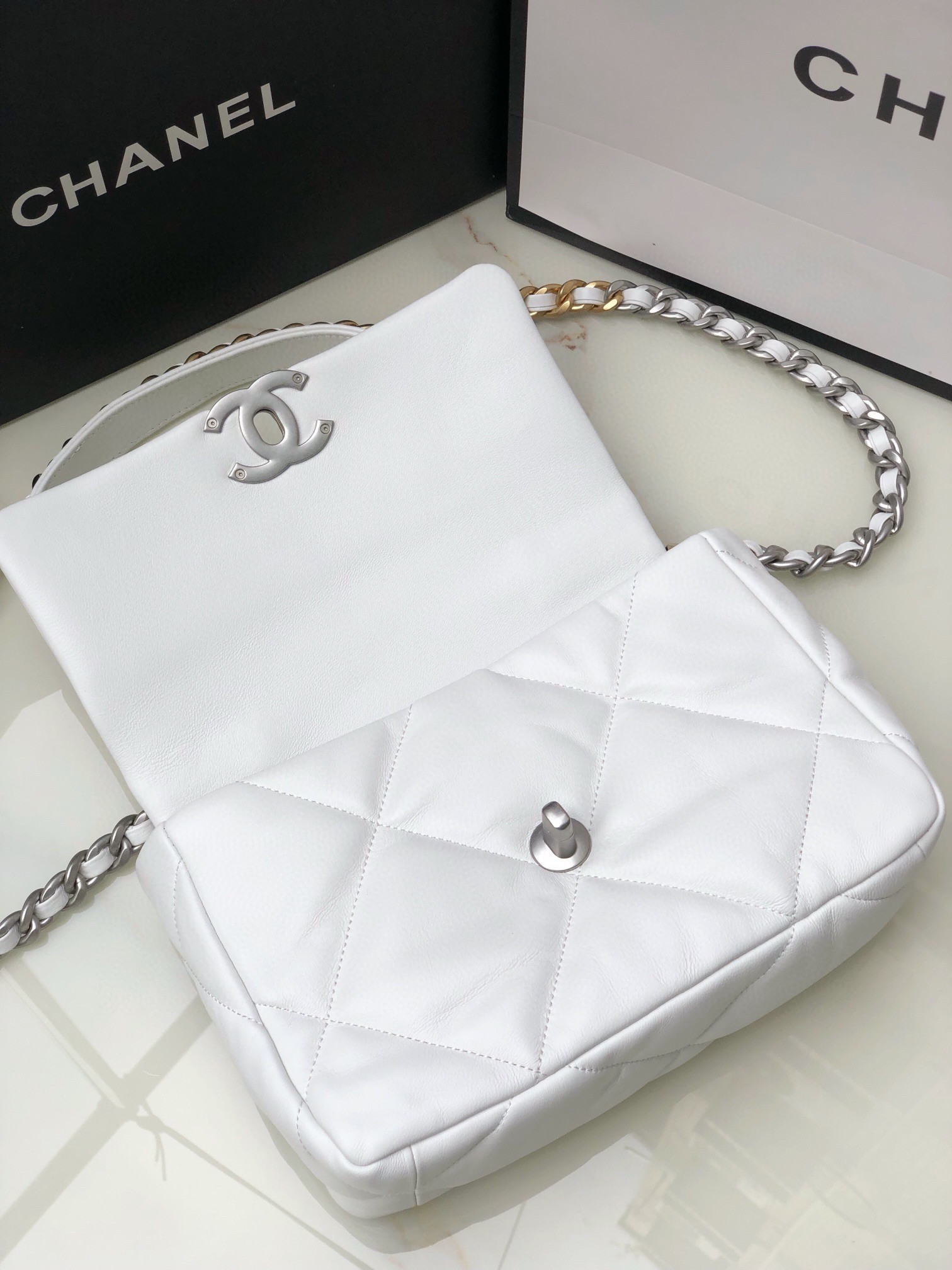Ch*el 19 handbag shiny leather, gold-tone, silver-tone & ruthenium-finish metal white 6.2 × 10.1 × 3.5 in